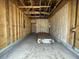 Unfinished garage showcasing framing, insulation, plumbing, and electrical components at 913 Dusk Dr, Summerville, SC 29486