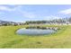 Rear yard with a pond and home exteriors on the other side of the pond in the community at 913 Dusk Dr, Summerville, SC 29486