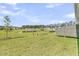 Green backyard with a view of a pond and the exteriors of other homes in the neighborhood at 913 Dusk Dr, Summerville, SC 29486