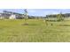 Green backyard area showing a pond and other houses around the pond at 913 Dusk Dr, Summerville, SC 29486