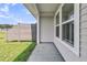 A view of the side yard showing the privacy fence, siding, and a small area of grass at 913 Dusk Dr, Summerville, SC 29486