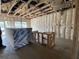 Unfinished room showing bare insulation, drywall, and construction materials at 913 Dusk Dr, Summerville, SC 29486