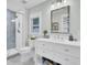 Modern bathroom with a glass shower, white vanity, and a framed mirror at 920 Simmons Ave, Summerville, SC 29483