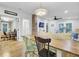 Bright dining area featuring a wooden table, exposed brick, and seamless flow to the living space at 920 Simmons Ave, Summerville, SC 29483