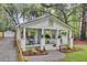 Inviting cottage with a rocking chairs, and lush landscaping at 920 Simmons Ave, Summerville, SC 29483