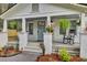 Inviting cottage front porch with rocking chairs and beautiful landscaping at 920 Simmons Ave, Summerville, SC 29483