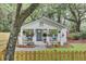 Charming cottage with a welcoming front porch, rocking chairs, and lush landscaping at 920 Simmons Ave, Summerville, SC 29483