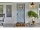 Welcoming front porch with blue door, showcasing charming details and inviting ambiance at 920 Simmons Ave, Summerville, SC 29483