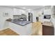 Updated kitchen featuring white cabinets, stainless steel appliances, and a breakfast bar with dark countertops at 920 Simmons Ave, Summerville, SC 29483