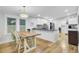 Bright kitchen and dining area with hardwood floors and sleek, modern appliances at 920 Simmons Ave, Summerville, SC 29483