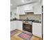 White kitchen cabinets, stainless steel appliances, and a modern range hood create a stylish cooking space at 920 Simmons Ave, Summerville, SC 29483