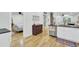 Open kitchen layout with stainless steel appliances and wood flooring leading to a bedroom at 920 Simmons Ave, Summerville, SC 29483