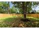 A large backyard is enclosed by a wooden fence and has a seating area at St, Charleston, SC 29407