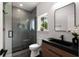 Modern bathroom featuring a sleek glass shower, a floating vanity and a large mirror at St, Charleston, SC 29407