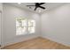 Bedroom with wood floors, a ceiling fan, and two windows at St, Charleston, SC 29407