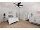 Bright bedroom with wood floors, a ceiling fan, and modern decor at St, Charleston, SC 29407