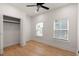 A well-lit bedroom featuring wood floors, a ceiling fan, and two windows with blinds at St, Charleston, SC 29407