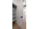 Open closet with white shelving and a view of the hallway and other rooms at St, Charleston, SC 29407