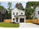A modern two story home with a black garage door and freshly cut lawn at St, Charleston, SC 29407