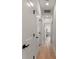 Hallway featuring light hardwood flooring, white walls, modern doors and black hardware at St, Charleston, SC 29407