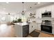 Bright, open kitchen with white cabinets, stainless steel appliances, and hardwood floors at St, Charleston, SC 29407