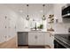 Bright, open kitchen features stainless steel appliances, hardwood floors, and modern pendant lighting at St, Charleston, SC 29407
