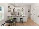Modern kitchen features white cabinets, stainless steel appliances, and stylish pendant lighting at St, Charleston, SC 29407
