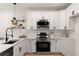 Modern kitchen with white cabinets, stainless steel appliances, and stylish decor accents at St, Charleston, SC 29407