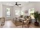 Bright living room with hardwood floors, natural light, neutral-toned furniture, and potted plants at St, Charleston, SC 29407