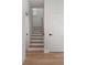 Bright stairway with wooden treads, white risers, handrail and matching white baseboards at St, Charleston, SC 29407