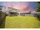 Spacious backyard with green grass, patio, screened-in porch, and privacy fence, offering a relaxing outdoor space at 106 Sago Ct, Summerville, SC 29486