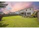 Beautifully landscaped backyard with lush lawn, patio, screened-in porch, and privacy fence, creating a private retreat at 106 Sago Ct, Summerville, SC 29486