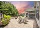 Cozy backyard patio with brick pavers, a screened-in porch, and a fire pit, perfect for entertaining at 106 Sago Ct, Summerville, SC 29486