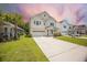 Charming two-story home with manicured lawn, two-car garage, and driveway at 106 Sago Ct, Summerville, SC 29486