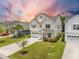 Well-manicured lawn surrounds a two-story home with a two-car garage and driveway at 106 Sago Ct, Summerville, SC 29486