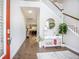 Stylish foyer with hardwood floors, staircase, console table, and decorative accents at 106 Sago Ct, Summerville, SC 29486