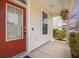 Exterior view of a charming front porch with a red front door and manicured landscaping at 106 Sago Ct, Summerville, SC 29486