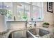 Stainless steel kitchen sink with granite countertops, subway tile backsplash, and a window view at 106 Sago Ct, Summerville, SC 29486