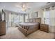 Bright main bedroom with a large bed, nightstands, and ample natural light from multiple windows at 106 Sago Ct, Summerville, SC 29486