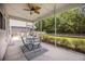 Screened in porch area features table and chairs with a ceiling fan at 106 Sago Ct, Summerville, SC 29486