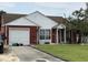 Cozy one-story home features an attached garage and covered front porch for relaxing at 107 Tabby Creek Cir, Summerville, SC 29486