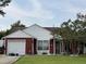 Charming single-story home with attached garage and inviting front porch swing at 107 Tabby Creek Cir, Summerville, SC 29486