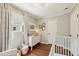 Bright Bedroom featuring a dresser with changing top, crib, and stylish decor at 1107 S Shadow Dr, Mount Pleasant, SC 29464