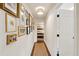 Hallway features hardwood floors, gallery wall, and leads to bedroom, creating a welcoming and stylish transition at 1107 S Shadow Dr, Mount Pleasant, SC 29464