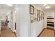 Hallway features hardwood floors, gallery wall, and leads to bedroom, creating a welcoming and stylish transition at 1107 S Shadow Dr, Mount Pleasant, SC 29464