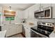 Well-equipped kitchen with white cabinets, tile backsplash, and stainless steel appliances at 1107 S Shadow Dr, Mount Pleasant, SC 29464