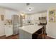 Bright kitchen with stainless steel appliances, a center island with chairs, and hardwood floors at 1107 S Shadow Dr, Mount Pleasant, SC 29464