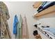 Organized walk-in closet with built-in shelving, hanging clothes, and neutral wall color at 1107 S Shadow Dr, Mount Pleasant, SC 29464