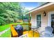 A wooden deck with table, chairs and a grill, overlooking a large grassy back yard at 112 Fox Chase Dr, Goose Creek, SC 29445