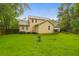 View of back of home overlooking the yard. There are trees and a grassy area with small trees at 112 Fox Chase Dr, Goose Creek, SC 29445
